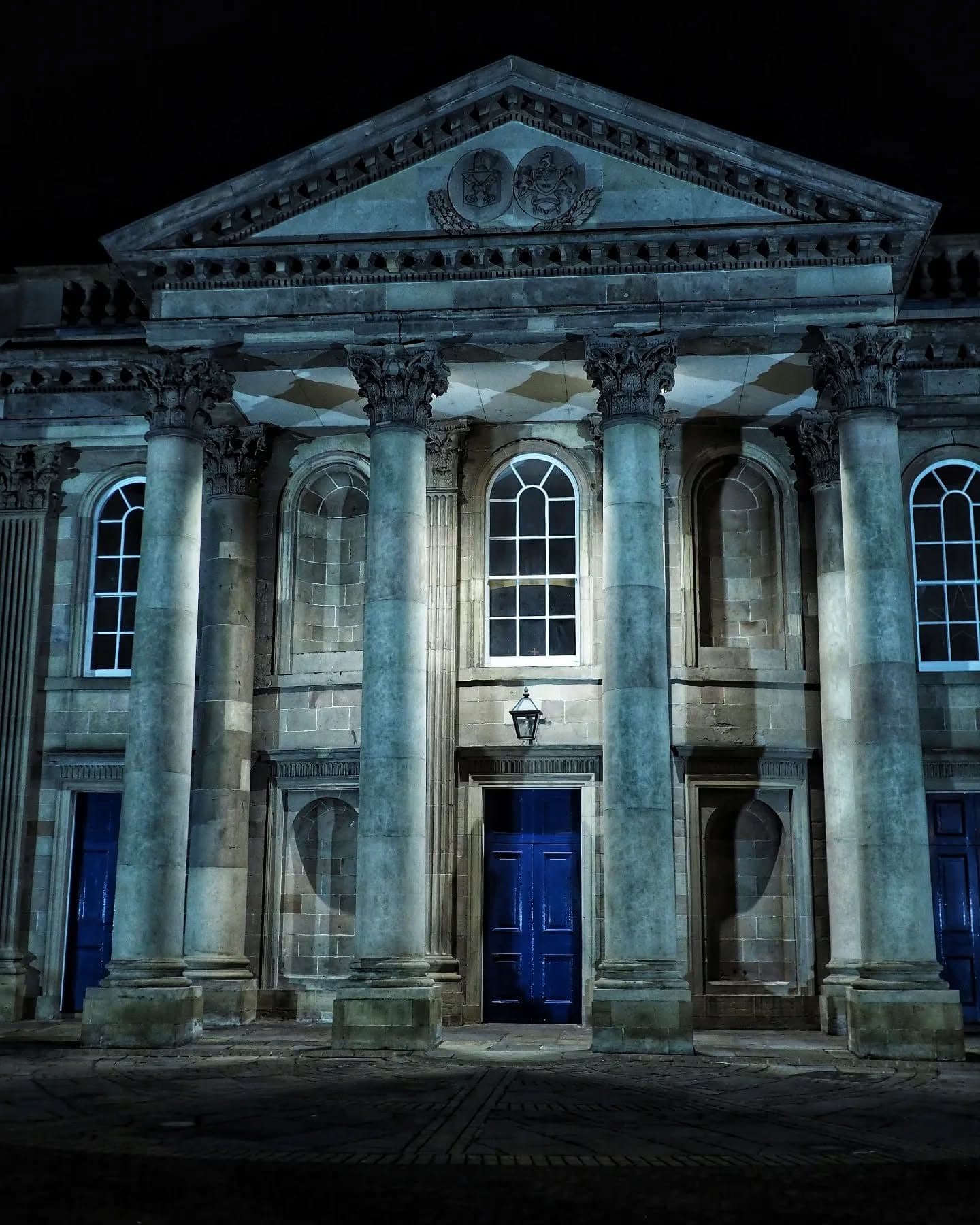 The Corinthian portico of St George's floodlit at night
