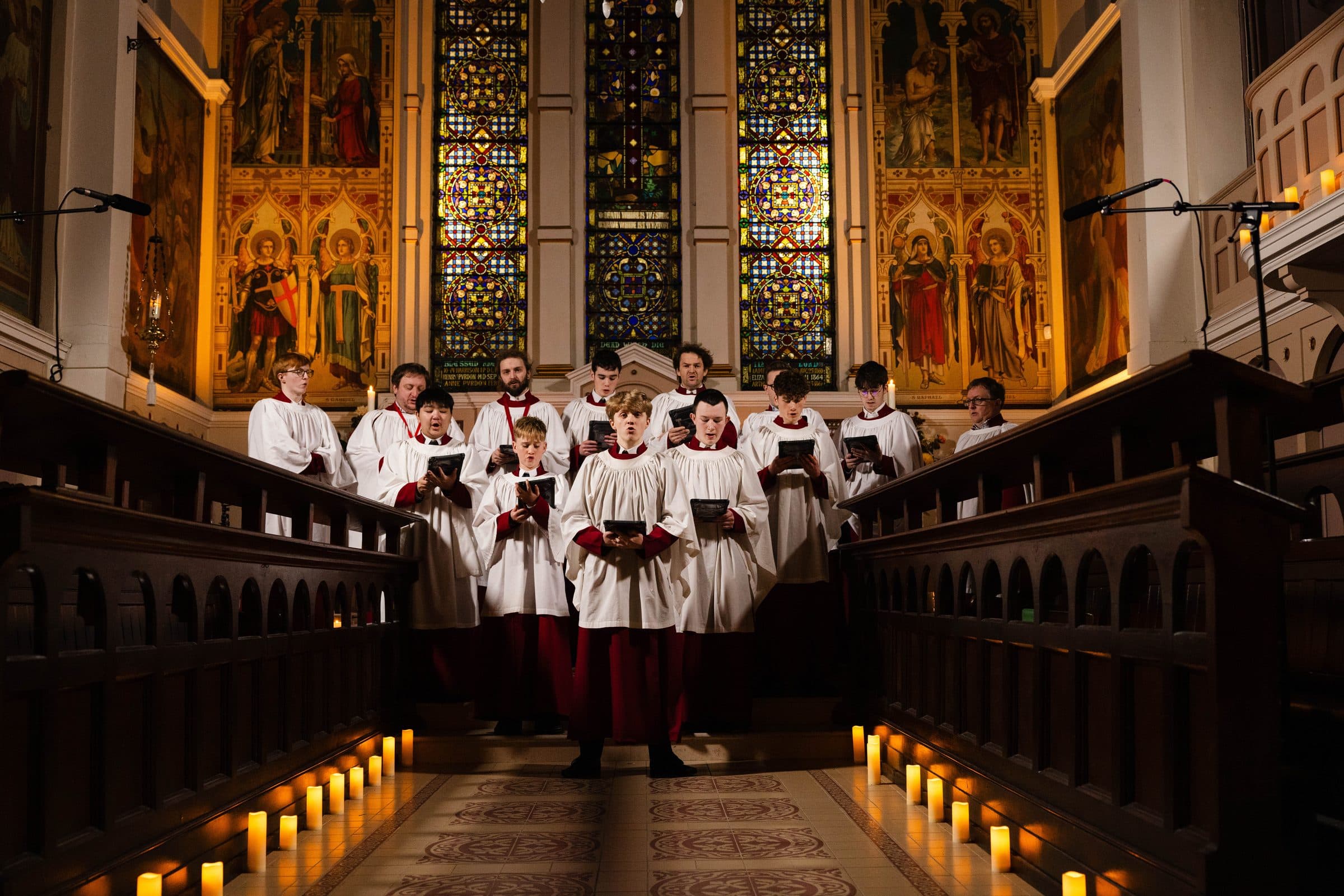 The Parish Choir of St George's singing by candlelight in the choir stalls